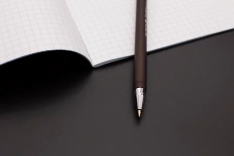 The fountain pen is on the notebook. dark background Stock Photos