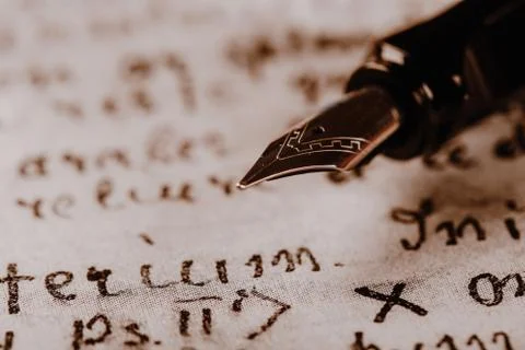 Fountain pen on paper with ink text closeup Stock Photos