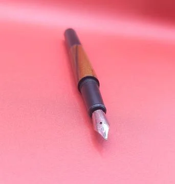 Fountain pen on red surface Stock Photos