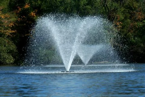 Fountain on a pond Stock Photos