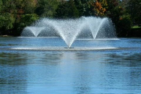 Fountain on a pond Stock Photos