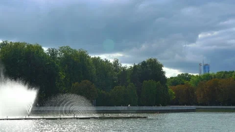Fountain in river against dramatic sky. Cityscape view. Stock Footage 159474055