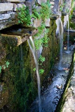 Fountain in rocks Stock Photos