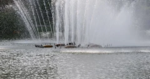 Fountain show displaying water patterns city park outdoor eye-level artistry in Видео 334795344