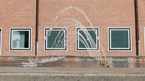 Fountain in slow motion in front of a brick wall, extremely slow water, day Stock Footage 160275909