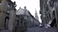 Fountain on small European street, view on Gothic church, quiet neighborhood 4k or 4k+ Resolution