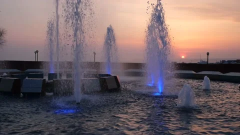 Fountain splashes with illumination at sunset Stock Footage 193991419