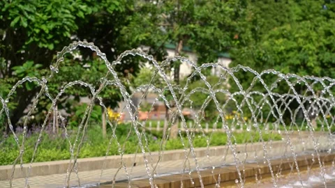 A fountain splashing water drops into the air Stock Footage