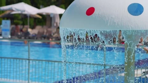 Fountain streams cascading down in a resort pool in slow motion 300fps Stock Footage 283438496