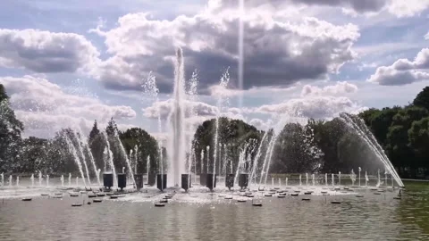 A fountain. Vertical jets of water fall against a cloudy sky on a summer day. Stock Footage 328102905