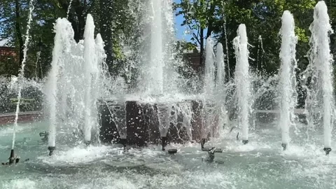 Fountain in a warm spring or summer city.  Stock Footage 240093428