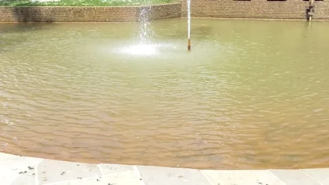 Fountain in the water of a park Stockbeeldmateriaal 334570465