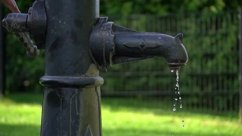 Fountain / well with drinking water in Vienna close up running water slow motion Stock Footage