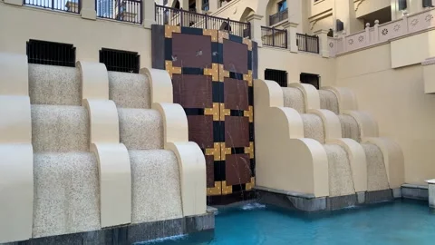 Fountain which looks like a tiny dam in a backyard of Souk al Bahar. Dubai, UAE Stock Footage 300032832