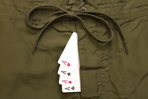 Four ace cards inside green jeans fly Stock Photos