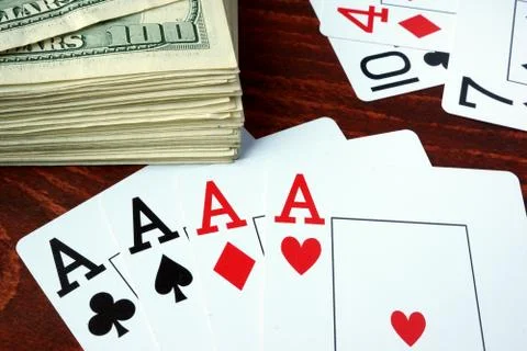Four aces and dollar banknotes. Gambling concept. Stock Photos
