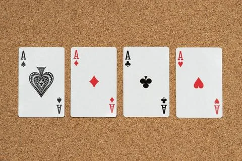 A four aces cards of a common deck over a cork background Stock-Fotos