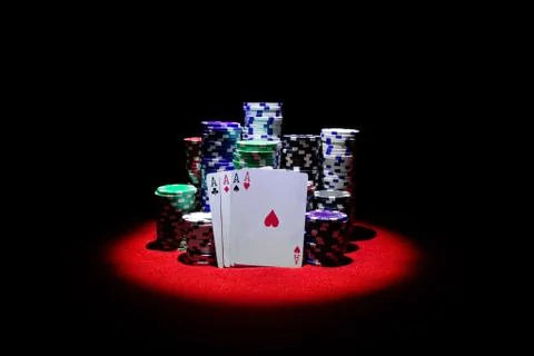 Four aces with chip stack on red table Stock Photos