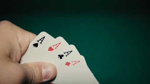 Four aces in his hands on the table Stock Footage 65381857