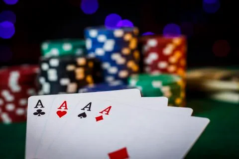Four aces on the poker table with chips Stock Photos