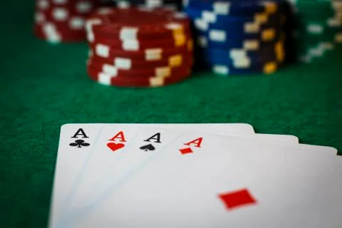 Four aces on the poker table with chips Stock Photos