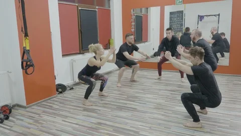 Four active young boys and a girl working out their body in a cross fit gym c Stock Footage 87202900