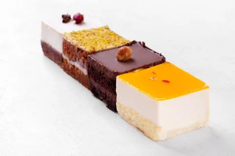 Four assorted cakes on the white table Stock Photos