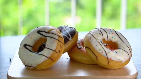 Four Assorted Unhealthy Donuts On Table Stock Footage 105839355