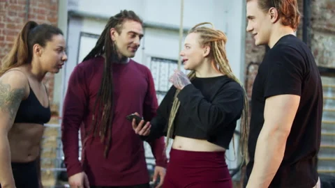 Four athletes are talking and looking at the phone Stock Footage 156304024