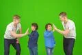 The four attractive brothers stand on the green background Photo