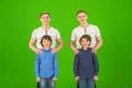 The four attractive brothers stand on the green background Photo