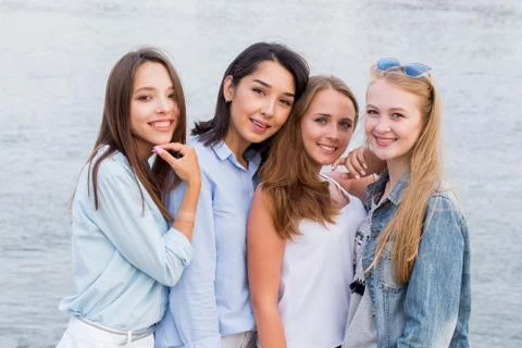 Four best girlfriends looking at camera together. people, lifestyle, friendsh Stock Photos