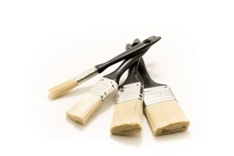 Four black paintbrushes Stock Photos