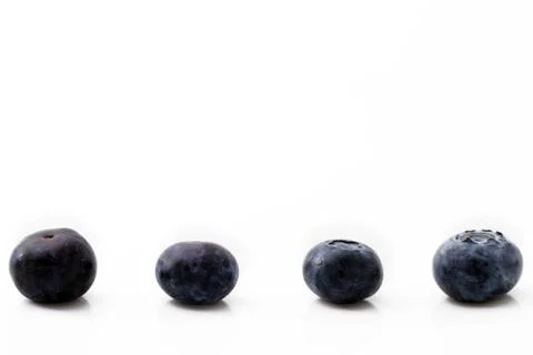 Four blueberries Stock Photos