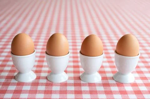 Four boiled eggs in a row Stock Photos