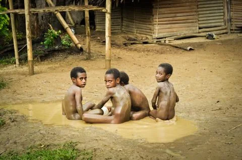 Four boys in mud Stock Photos