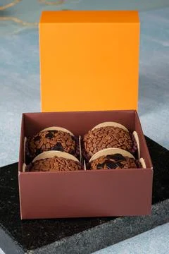 Four brigadiers inside a box on a marble stone. In the background, the lid of Stock Photos