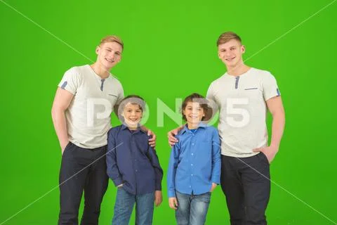 The four brothers stand on the green background Stock Photos