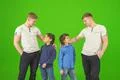 The four brothers stand on the green background Photo