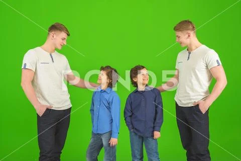 The four brothers stand on the green background Stock Photos