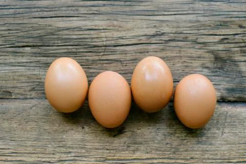 Four Brown Eggs Lined Up on a Table Stock Photos