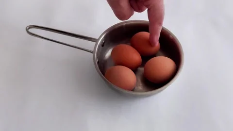 Four Brown Eggs in Small Stainless Steel Saucepan Video stock 325982692