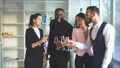 The four business people clink glasses. slow motion 4k or 4k+ Resolution