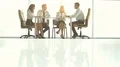 The four business people discuss at the table 4k or 4k+ Resolution