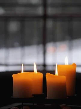 Four candles burning Stock Photos