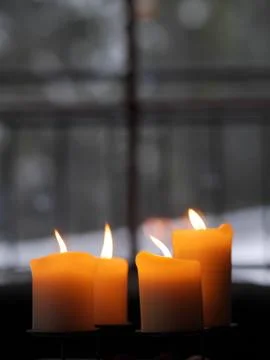 Four candles burning Stock Photos