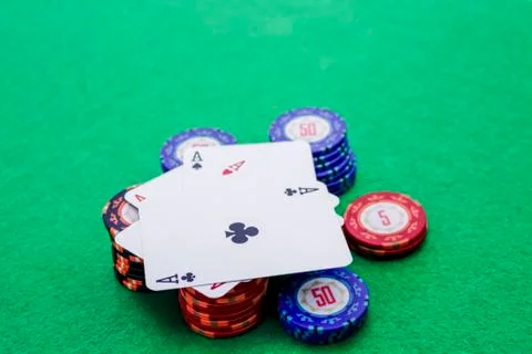 Four cards with aces on a stack of poker chips Stock Photos