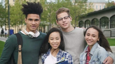 Four charming smiling friends is standing before camera in slow mode Stock Footage 101794034
