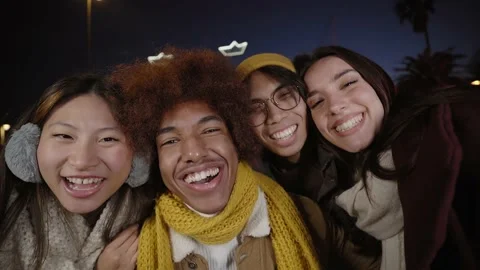 Four cheerful young friends taking selfie portrait in winter clothes. Happy Stock Footage 229503073