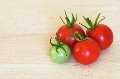 Four cherry tomatoes Stock Photos